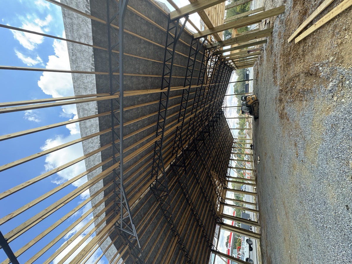 Exterior close-up of the main entrance framing at Thompsons Station Hardware construction in Franklin, TN, highlighting the detailed wooden structure of the entryway.
