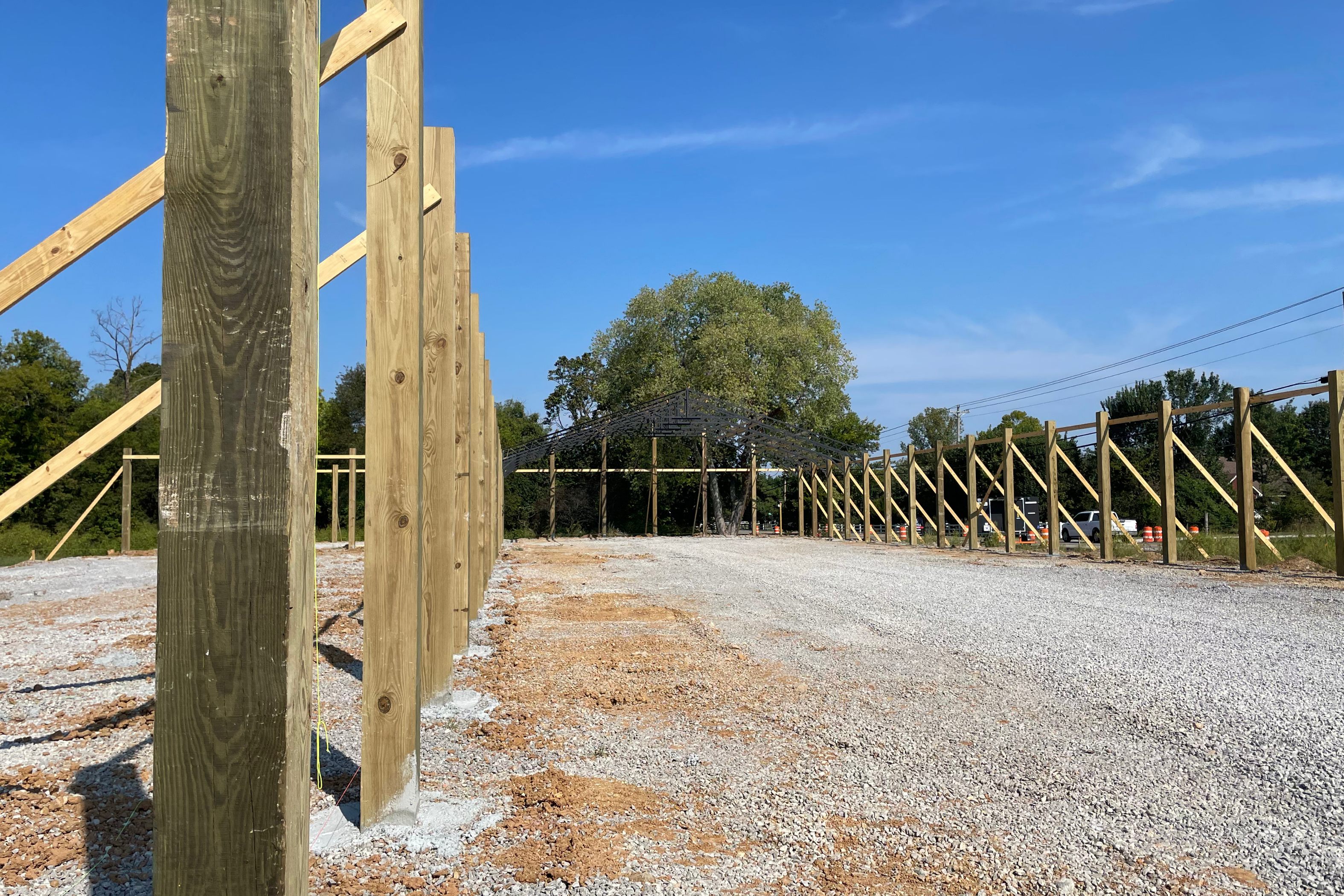 Mid-construction phase showing completed steel framing and structural work for the hardware store building